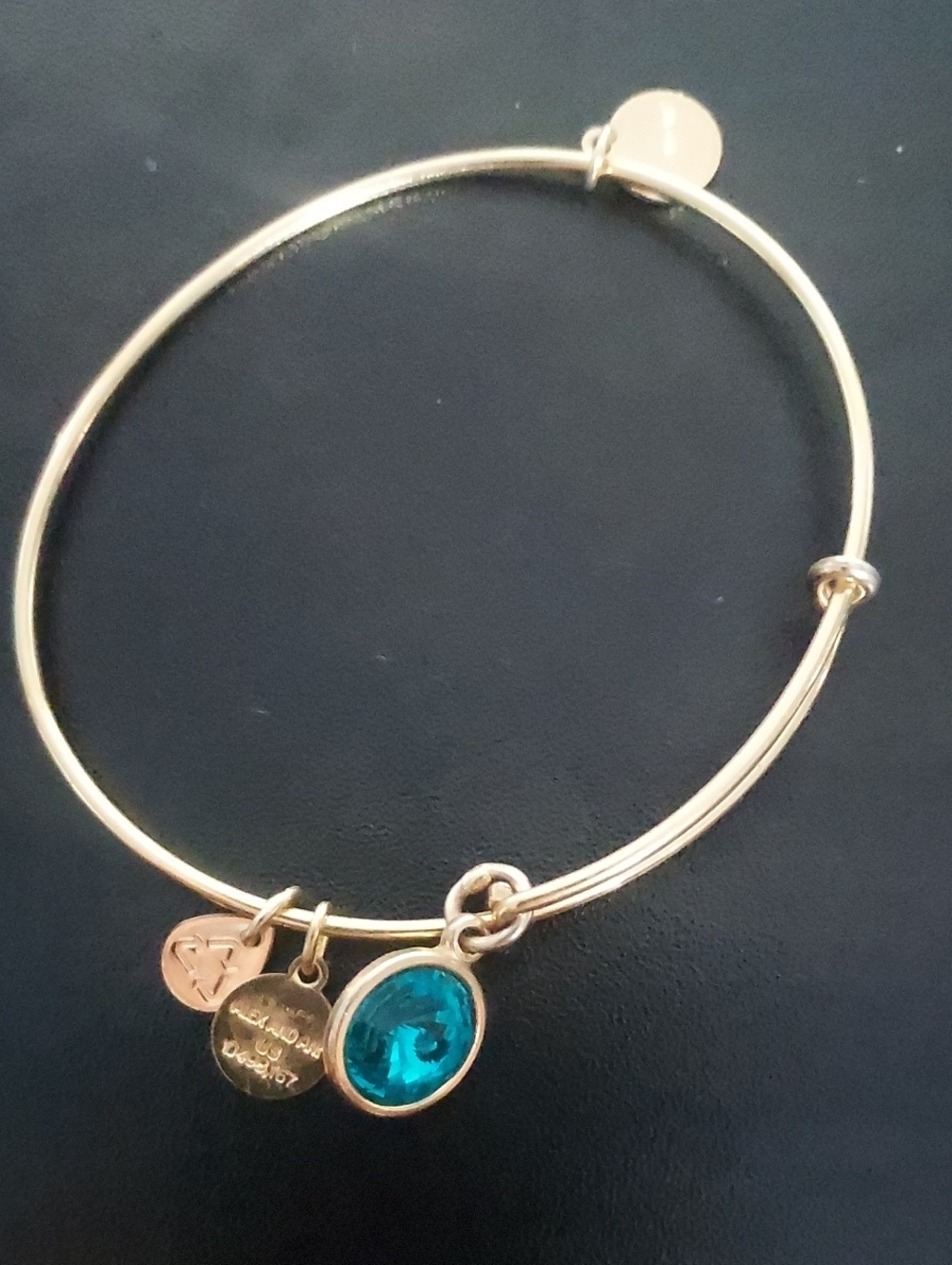 Gold Tone Bangle Bracelet with Emerald Crystal Charm